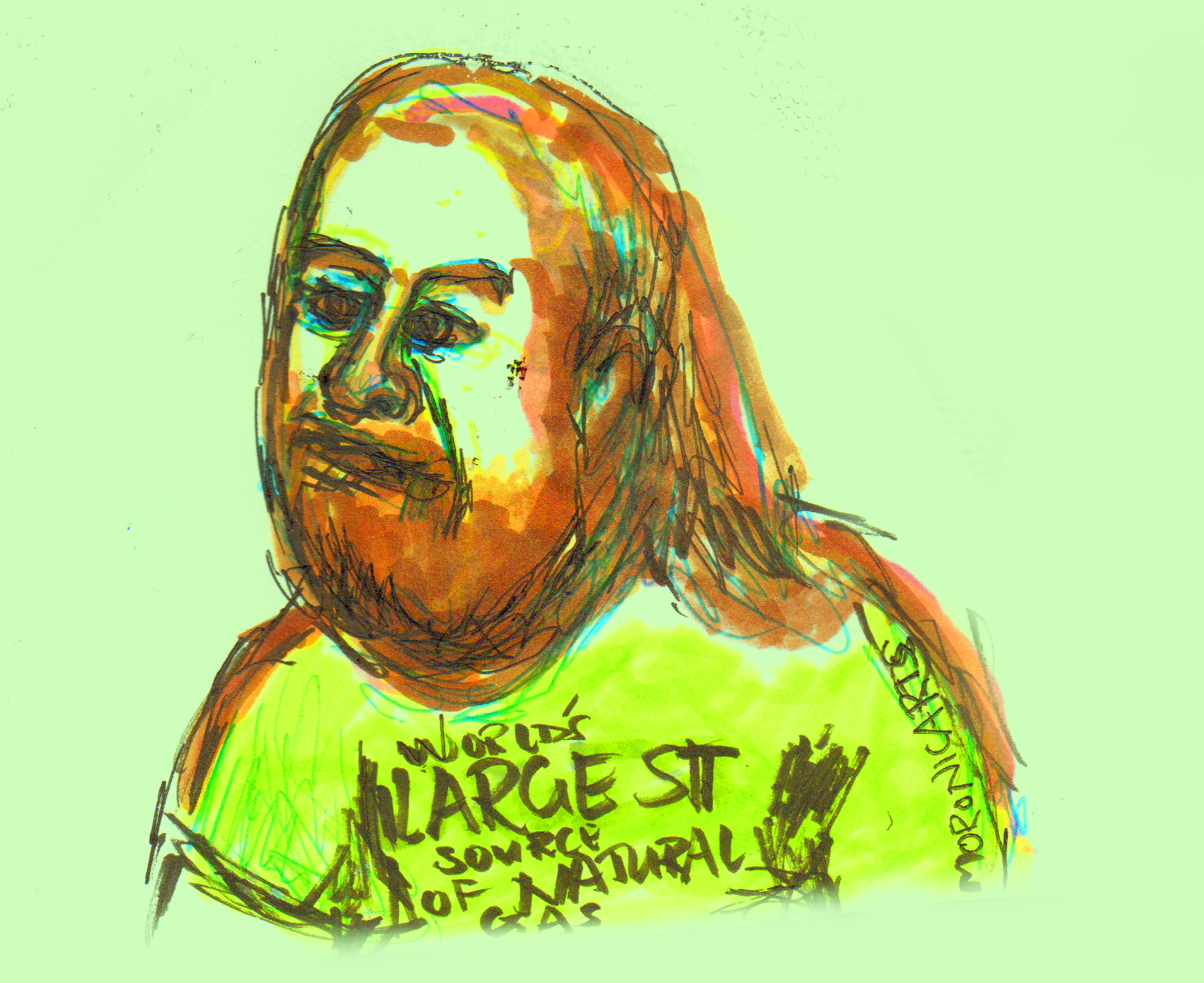 Image: a bald, stocky male with shoulder length orange hair and an orange beard clenches his jaw and looks to the left. Text: shirt reads "World's largest source of natural gas."
